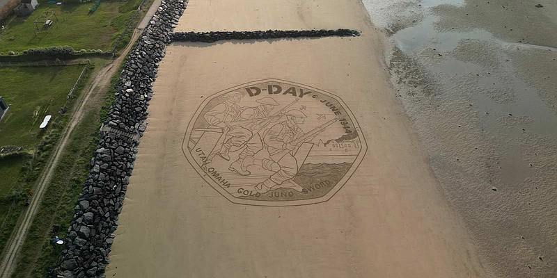 A recreation of The Royal Mint's commemorative coin design in sand on 'Gold Beach' in Normandy, northern France.