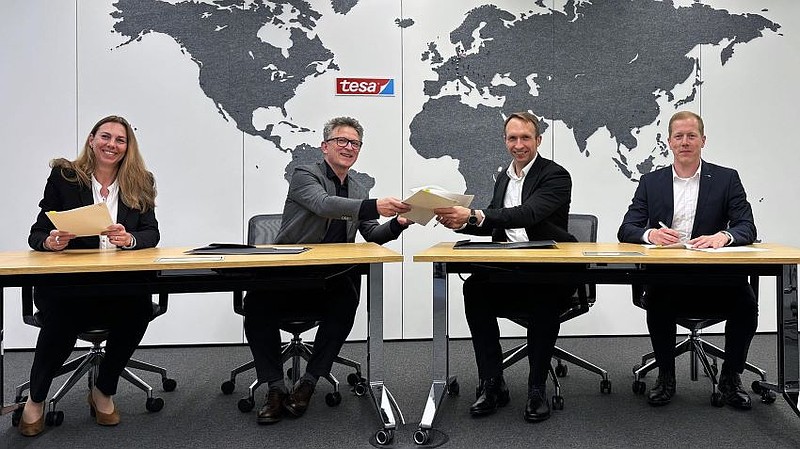 Signing of the agreement at tesa SE’s Global Headquarters. From left to right: Dr Ingrid Sebald (Board Member Technology tesa), Dr Norman Goldberg (CEO tesa), André Kutz (Head of ZEISS Photonics & Optics), and Roman Kleindienst (Head of ZEISS Microoptics / EVP ZEISS Microoptics) formalise the strategic partnership between tesa and ZEISS to industrialise large-area holography technology.