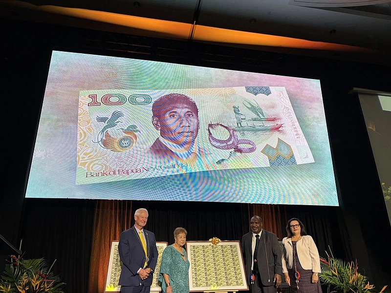The Bank of Papua New Guinea presenting framed uncut sheets of the newly released 100 kina banknote to Prime Minister James Marape and Lady Stella Chan, pictured here (centre) with Note Printing Australia CEO Malcolm McDowell on the left, and Governor of the Bank, Elizabeth Genia, on the right.